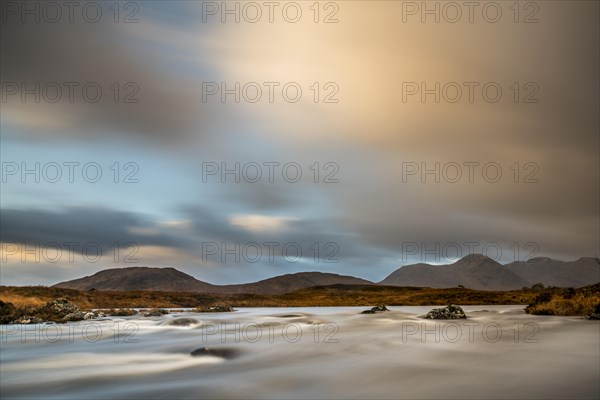 River Ba with mountain peaks in the background and dramatic clouds