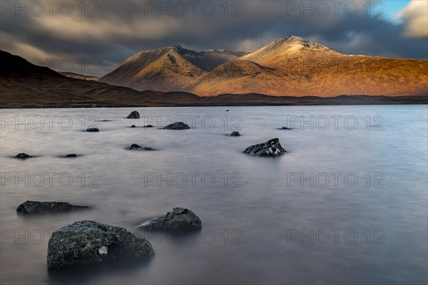 River Ba with mountain peaks of Meall aÂ´Bhuiridh and Clach Leathad in the background and dramatic clouds