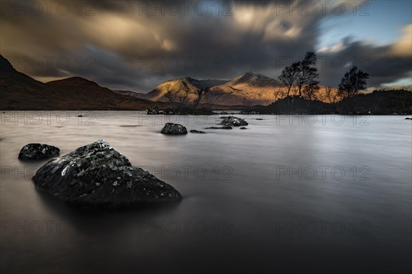 River Ba with mountain peaks of Meall aÂ´Bhuiridh and Clach Leathad in the background and dramatic clouds