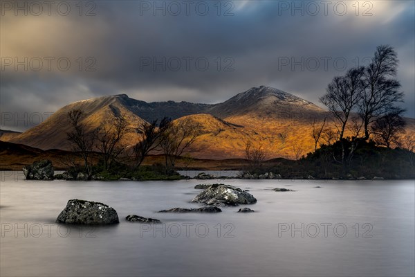 River Ba with mountain peaks of Meall aÂ´Bhuiridh and Clach Leathad in the background and dramatic clouds