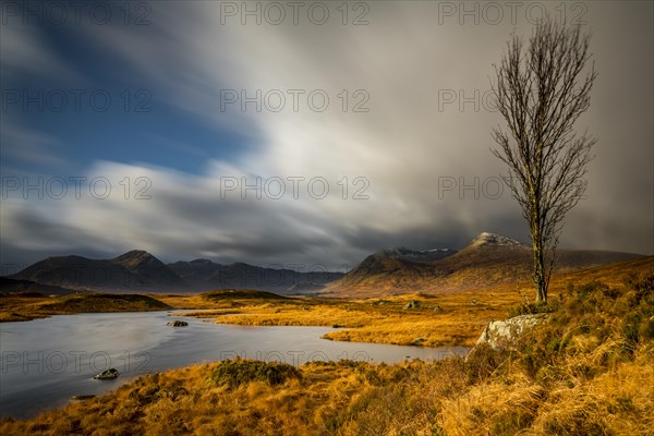 River Ba with mountain peaks of Meall aÂ´Bhuiridh and Clach Leathad in the background and dramatic clouds