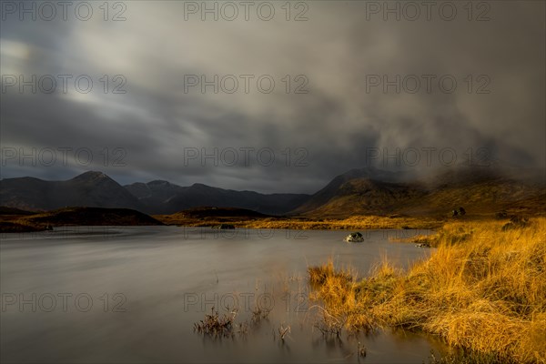 River Ba with mountain peaks of Meall aÂ´Bhuiridh and Clach Leathad in the background and dramatic clouds