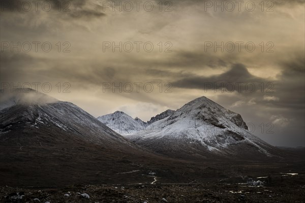 Snowy mountain tops of Ben Lee with clouds in Highland landscape