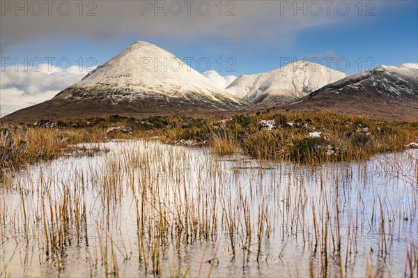 Moor landscape with snow-covered peaks of the Cullins Mountains in Highland Landscape