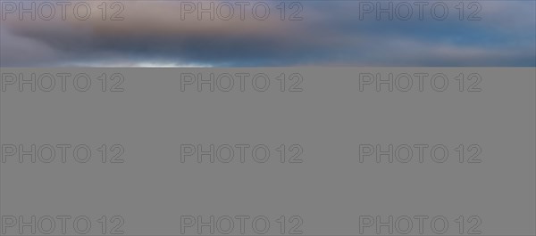 Mountains reflected in water surface with fog