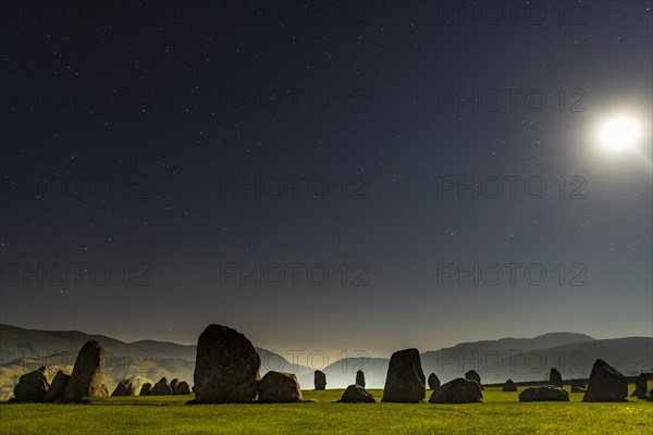 Stone circle at full moon with starry sky