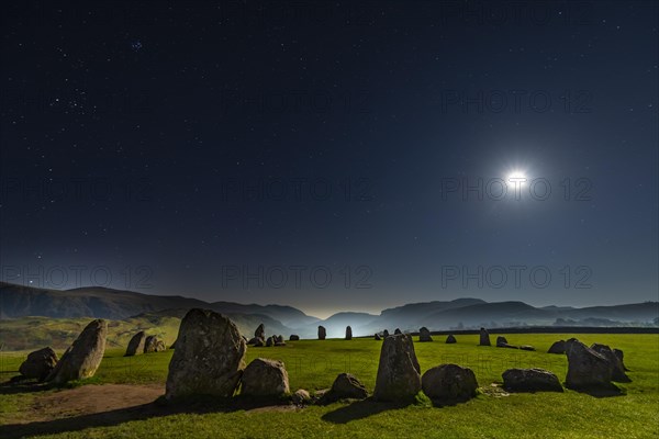 Stone circle at full moon with starry sky