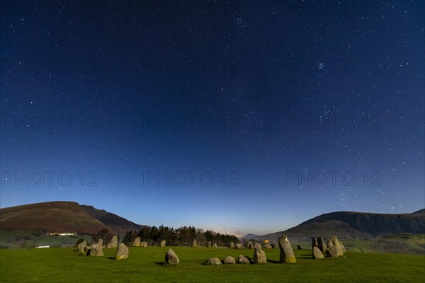 Stone circle at full moon with starry sky