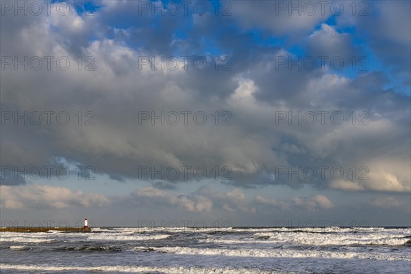 Berwick Lighthouse in strong surf and cloudy sky