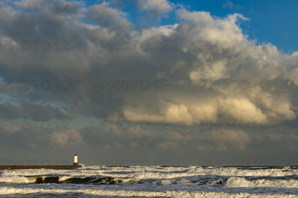 Berwick Lighthouse in strong surf and cloudy sky