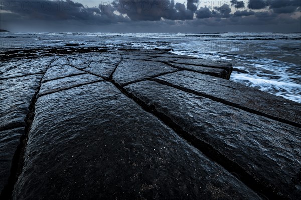 Coast with granite rocks washed by the sea in the evening light