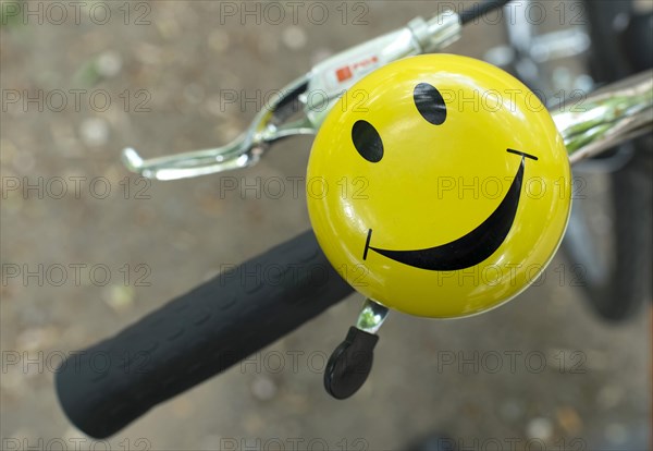 Bicycle handlebars with bell with laughing smiley