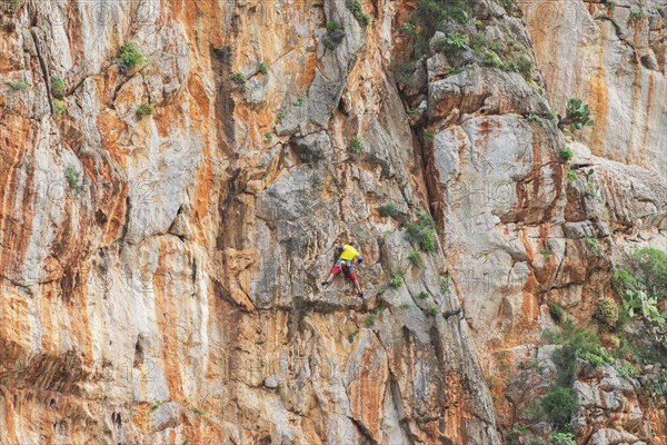 Man climbs on rock face