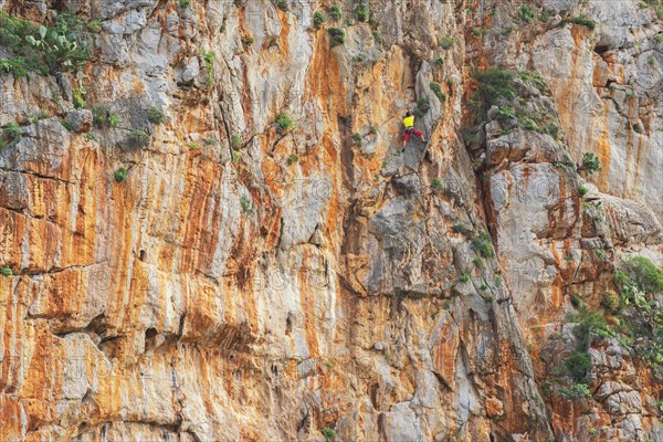 Man climbs on rock face