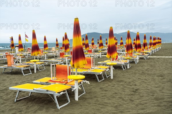 Folded sunshades and beach chairs