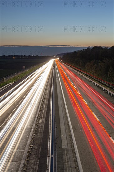 Road with light tracks at dusk