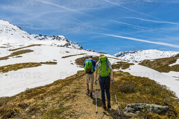 Two hikers hiking on trail