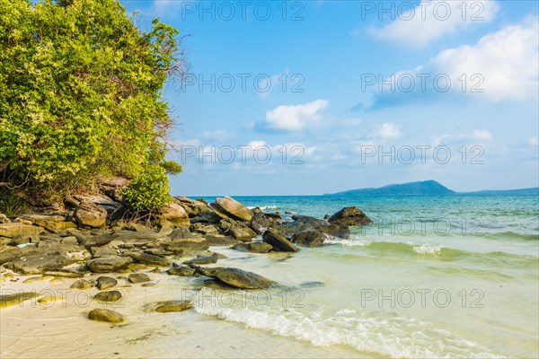 Idyllic sandy beach with rocks