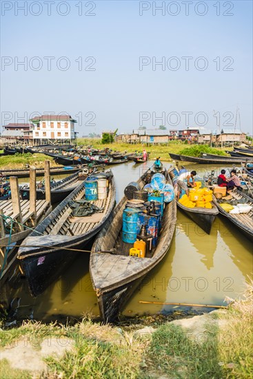 Wooden boats with old oil barrels in the harbor