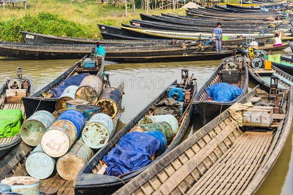 Wooden boats with old oil barrels in the harbor