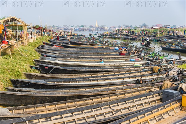 Many wooden boats lined up at dock in the harbor