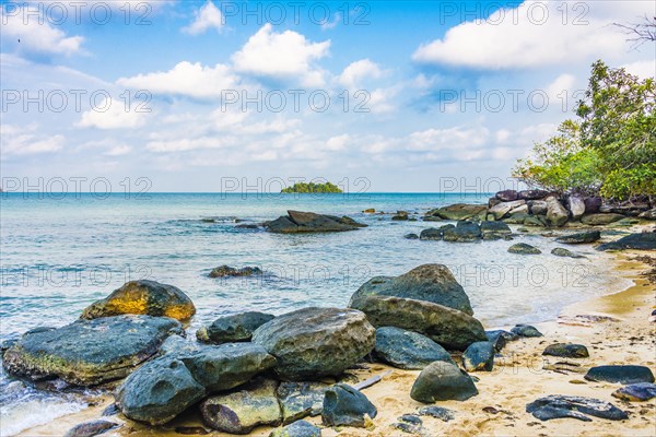 Idyllic sandy beach with rocks