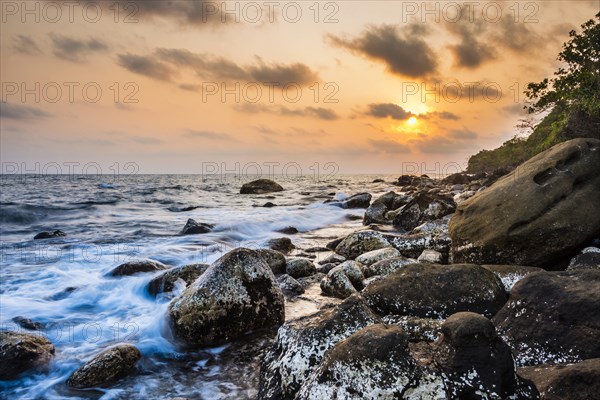 Sunset at rocky coast near Long Beach in Sok San village on Koh Rong island