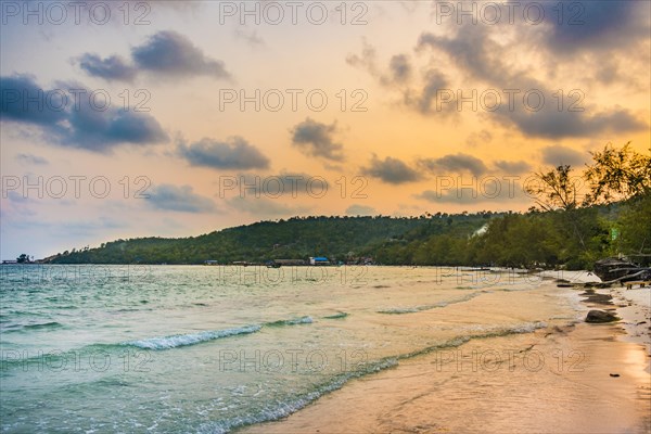 Idyllic sandy beach with turquoise water at sunset