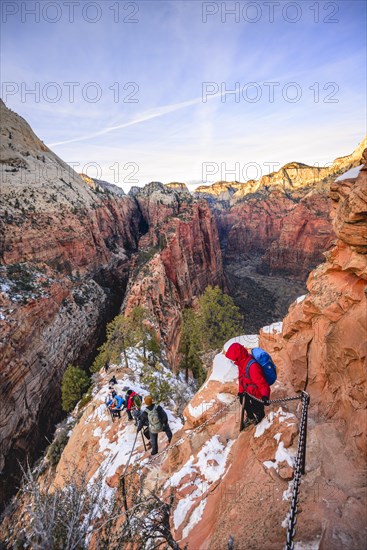 Young woman hikes on the via ferrata descending from Angels Landing