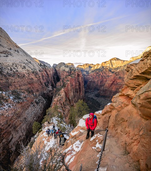 Young woman hikes on the via ferrata descending from Angels Landing