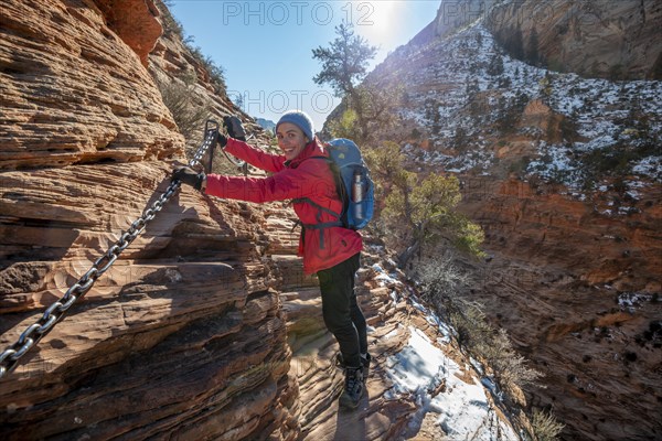 Young woman hiking on the via ferrata of the Angels Landing Trail