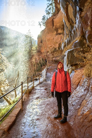 Female hiker in front of waterfall