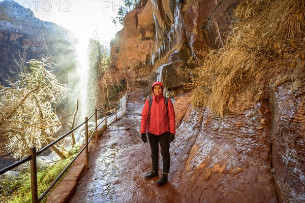 Female hiker in front of waterfall