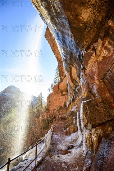 Waterfall falls from overhanging rock