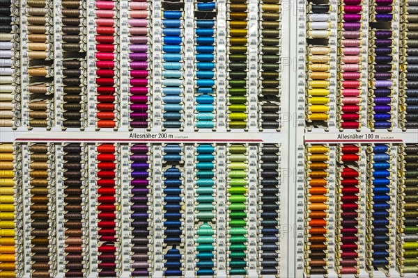 Colorful spools with sewing thread in many colors in a department store