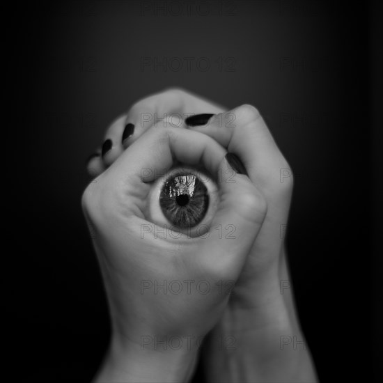 Hands holding artificial eye