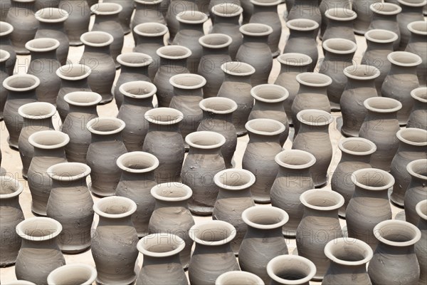 Rows of pots drying in the sun in potters square