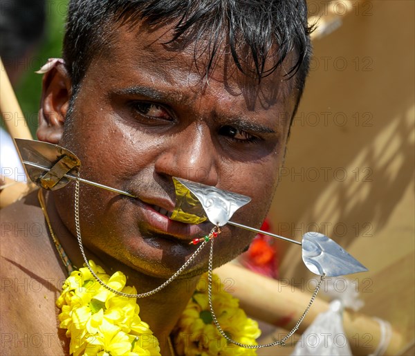 Kavadi dancers with pierced cheeks