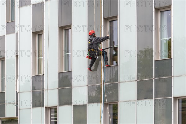 Window cleaner on skyscraper facade