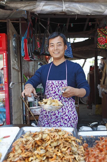 Man frying crayfish