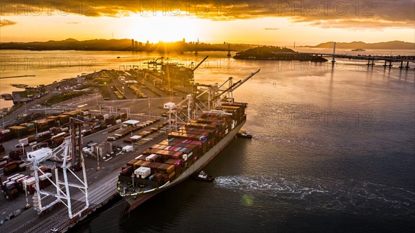 Cargo ship at sunset in the Port of Oakland
