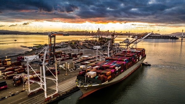 Cargo ship at sunset in the Port of Oakland