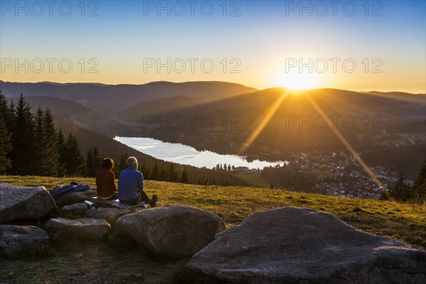 Older couple at Hochfirst with view to Titisee and Feldberg at sunset