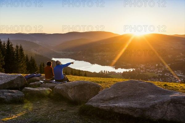 Older couple at Hochfirst with view to Titisee and Feldberg at sunset