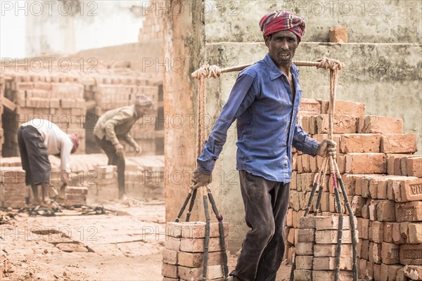 Brickworks worker transports bricks