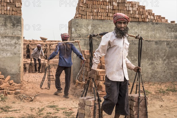 Brickworks worker transports bricks