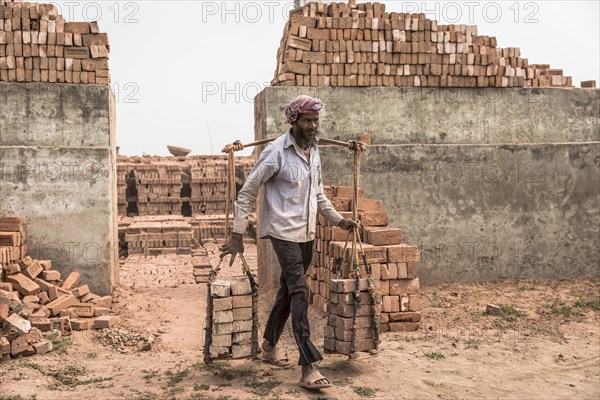 Brickworks worker transports bricks