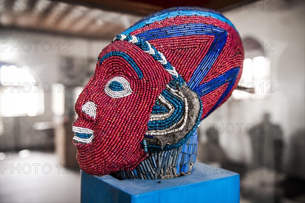 Sculpture decorated with glass and ceramic beads