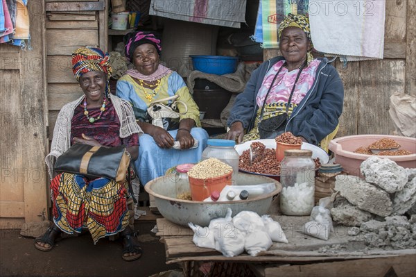 Saleswomen sitting at market stall