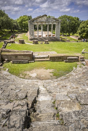 Odeon with rows of seats in front of the ruins of a Doric Buleuterion